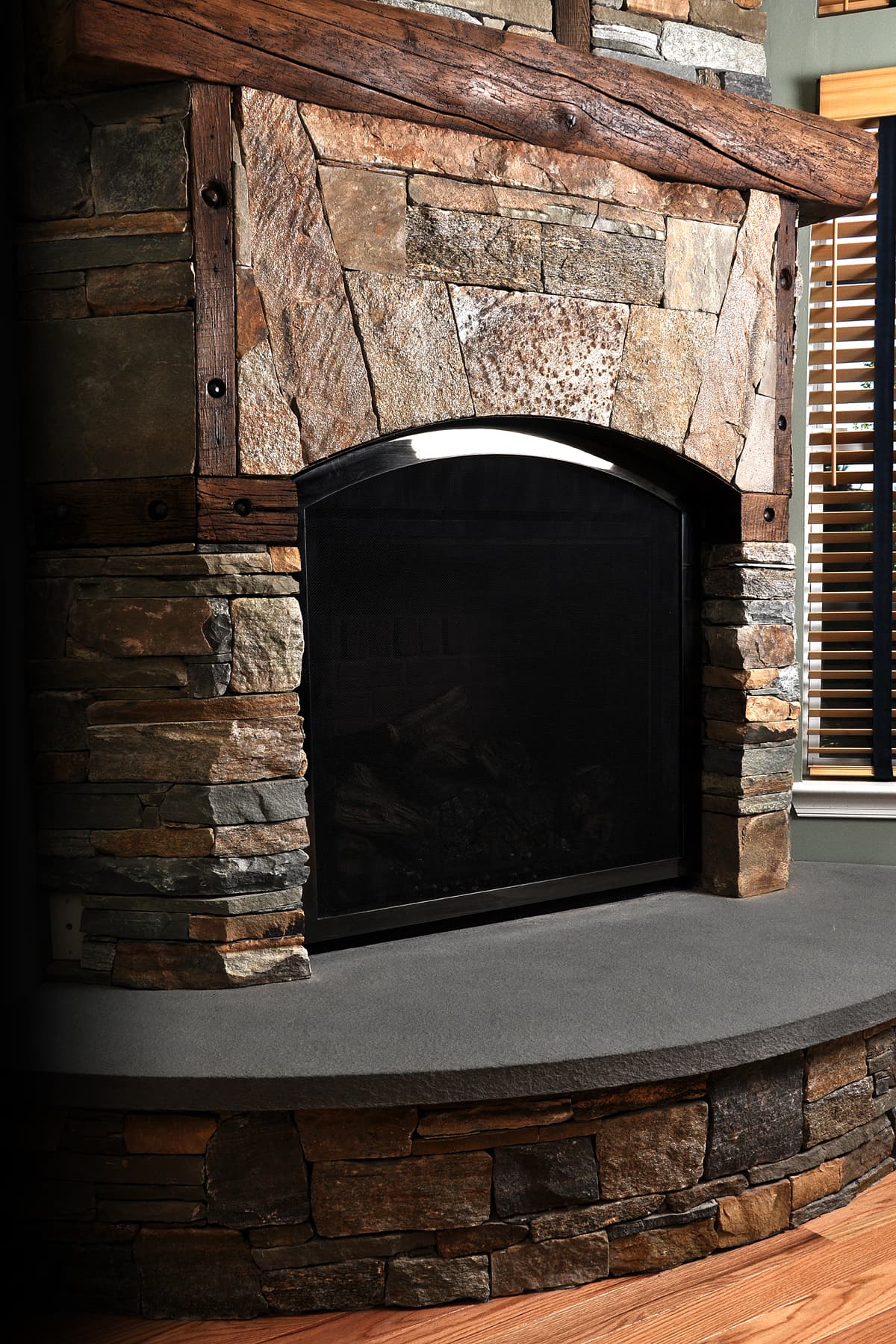 Stone fireplace with classic ironworks and re-purposed wood from a fallen down barn